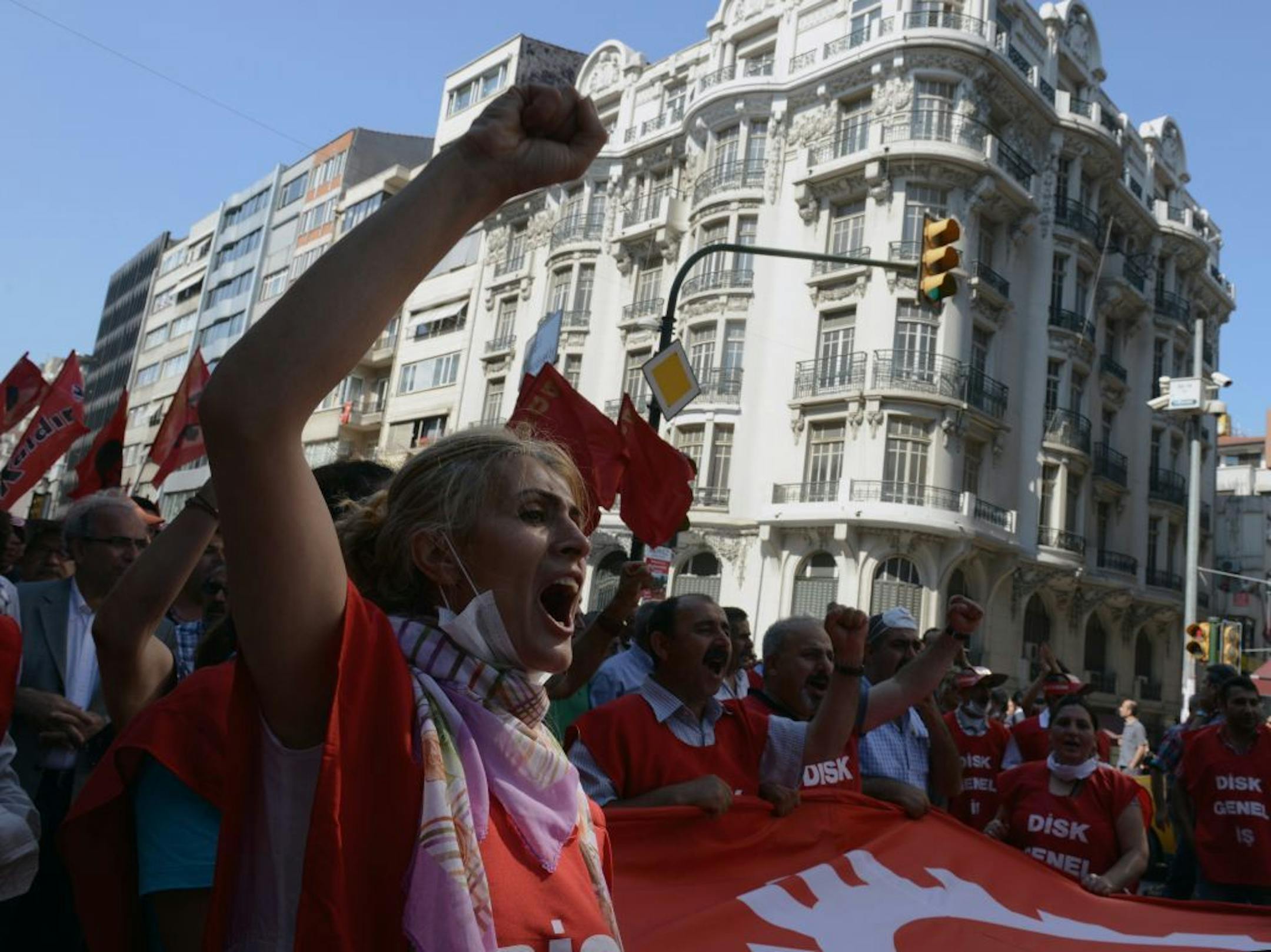 People shout anti-government slogans during a rally by the labor unions in Istanbul, Turkey, Monday, June 17, 2013. A day earlier, riot police cordoned off streets, set up roadblocks and fired tear gas and water cannons to prevent anti-government protesters from an effort to return to Taksim Square in Istanbul. Labor unions and political foes of Prime Minister Recep Erdogan rallied Monday by the thousands across Turkey, hoping to capitalize on weeks of protest that began as small-scale activism