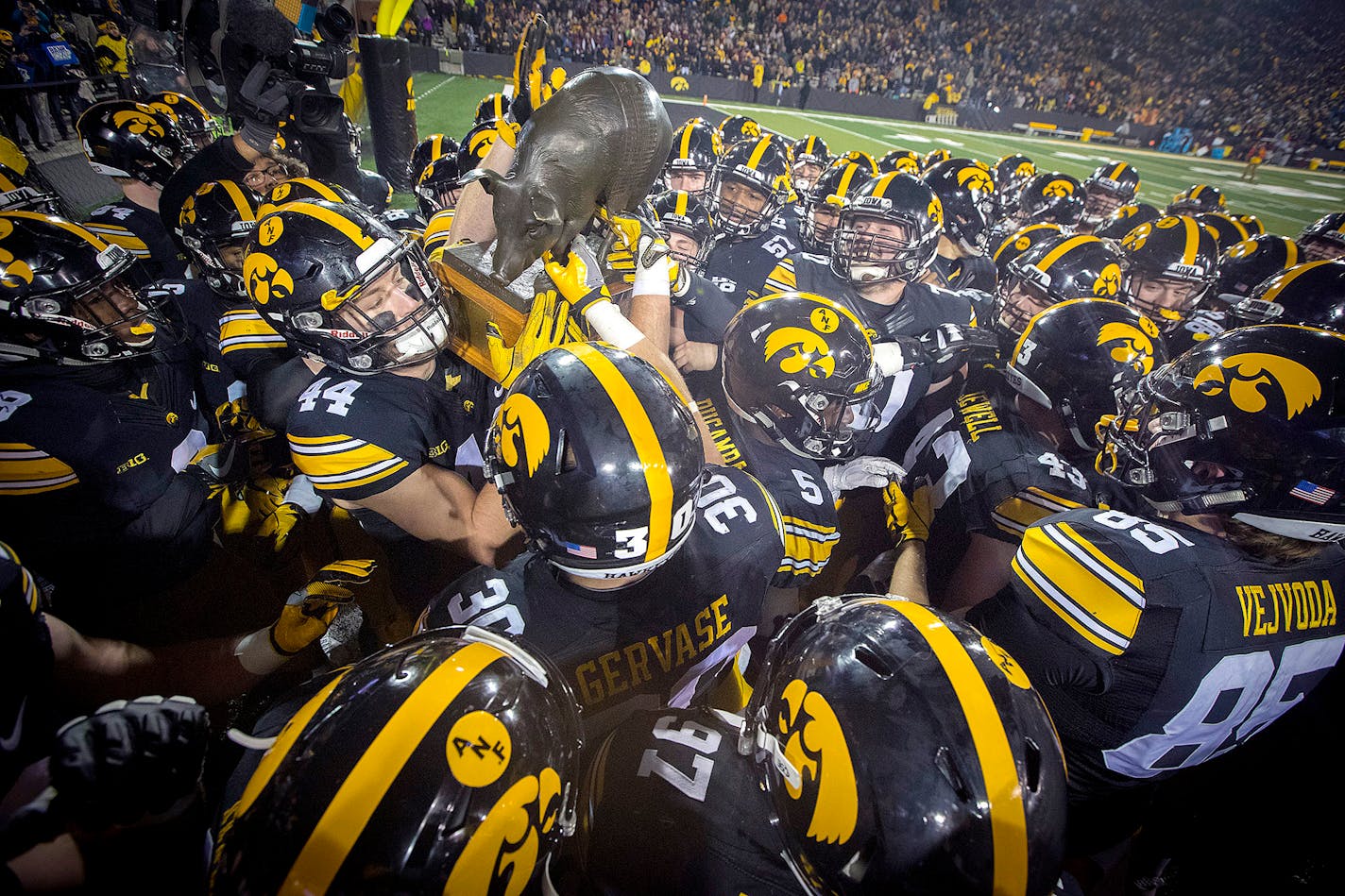 Floyd of Rosedale is picked up by the Iowa team after they defeated Minnesota 17-10 at Kinnick Stadium