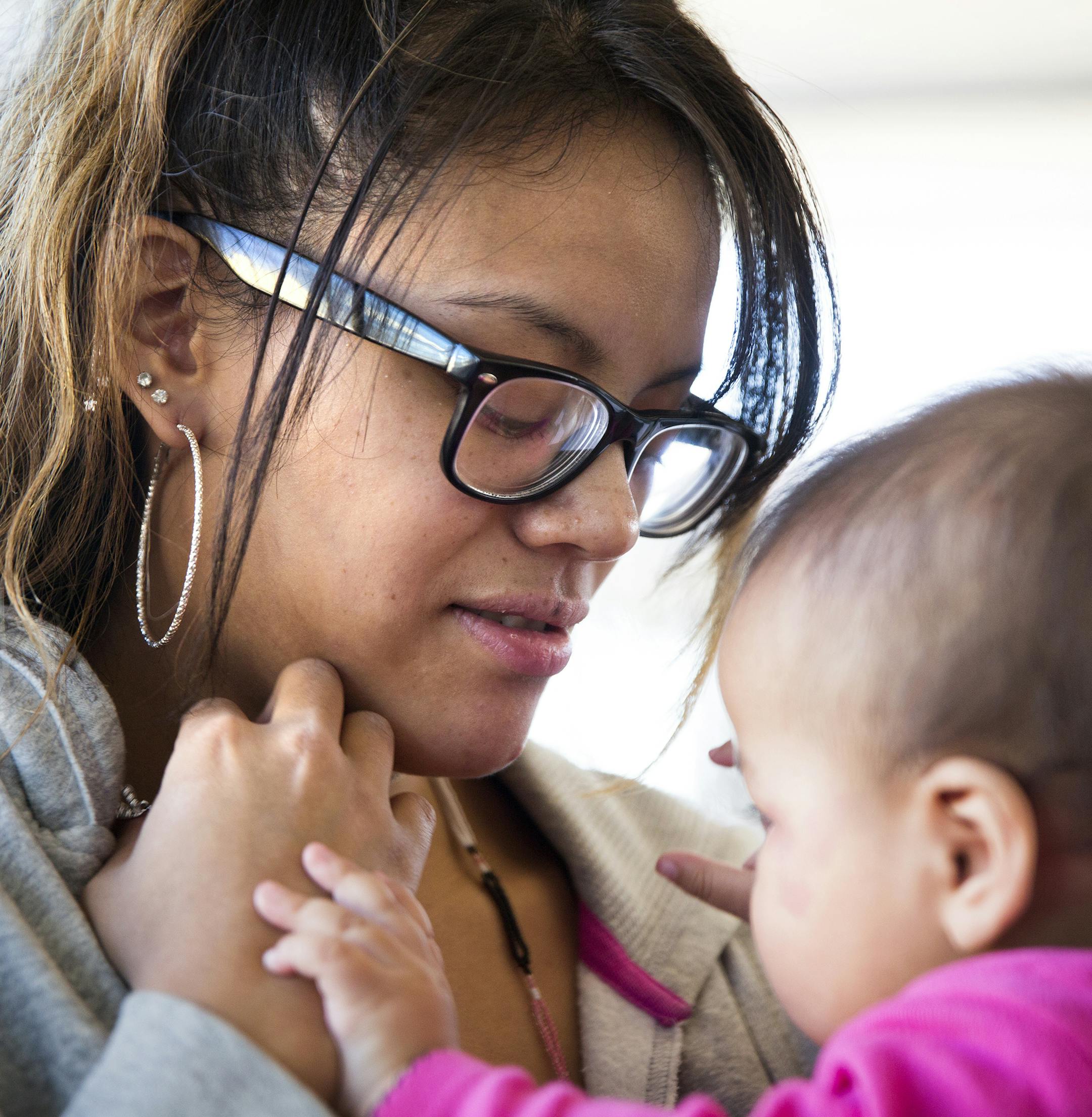 Leah Rozie studies for her GED with her 7-month-old daughter Kikaa at East Lake Library in Minneapolis on Tuesday, February 24, 2015. ] LEILA NAVIDI leila.navidi@startribune.com / BACKGROUND INFORMATION: Leah Rozie, 21, underwent intensive treatment for heroin addiction during her pregnancy with a highly successful program through Hennepin County. (Leah Rozie did not want to show her daughter's face or give her daughter's full name. Kikaa is her nickname.)