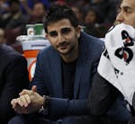 Minnesota Timberwolves' Ricky Rubio (9) of Spain looks on in street clothes with Kevin Martin (23) during the first half of an NBA basketball game aga