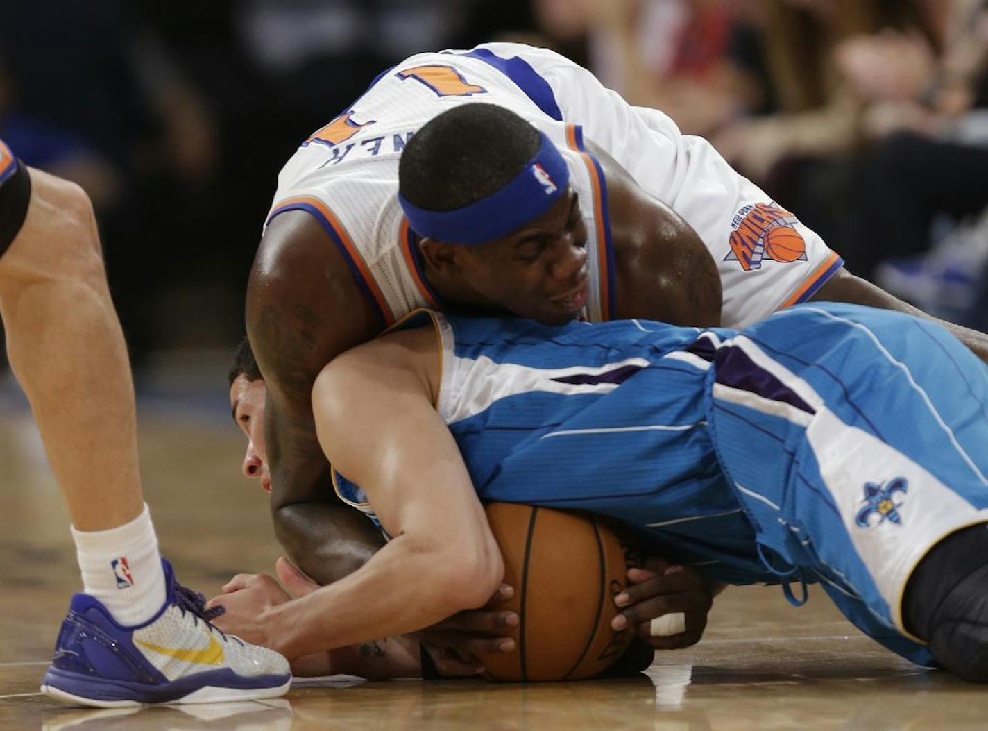 New York Knicks forward Ronnie Brewer (11) and New Orleans Hornets guard Austin Rivers (25) scuffle for a loose ball on the floor in the first half of their NBA basketball game at Madison Square Garden in New York, Sunday, Jan. 13, 2013. The dispute over control was settled with a jump ball at center-court.