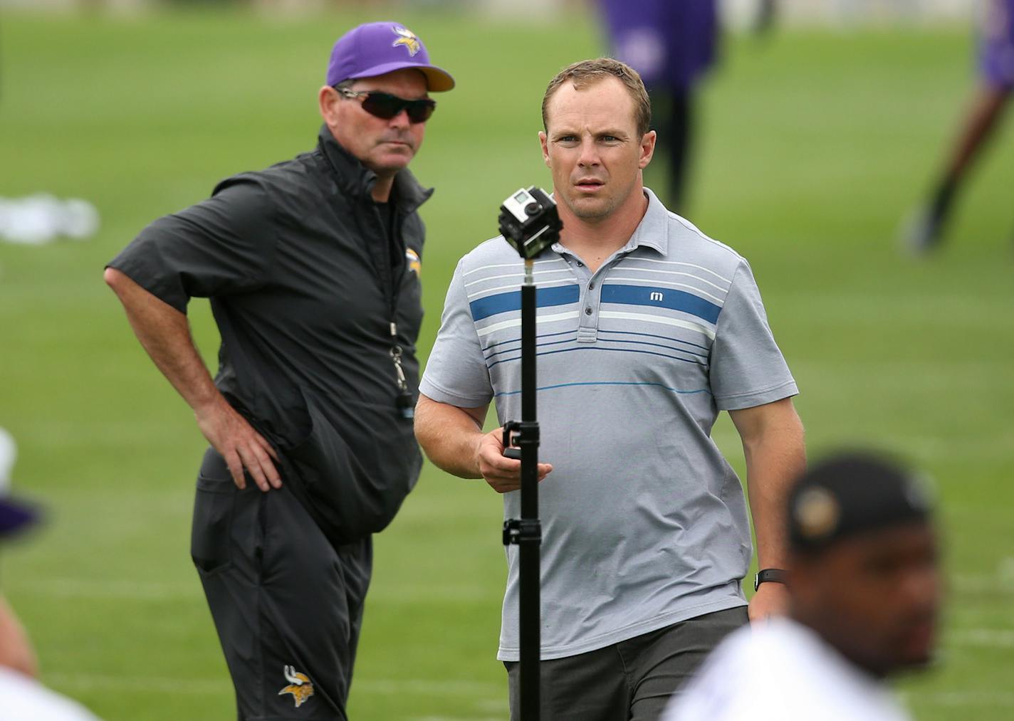 Vikings head coach Mike Zimmer left watched former Vikings linebacker Heath Farwell place a virtual reality technology camera on the field during Vikings training camp at Minnesota State University Monday July 27, 2015 in Mankato, MN. Jerry Holt/ Jerry.Holt@Startribune.com