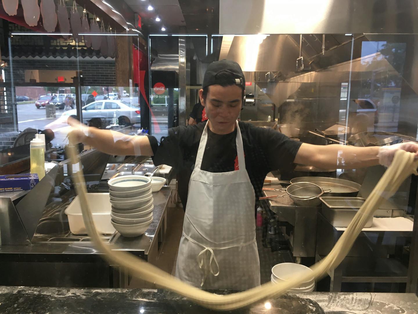 Demonstrating the art of hand-pulled noodles.