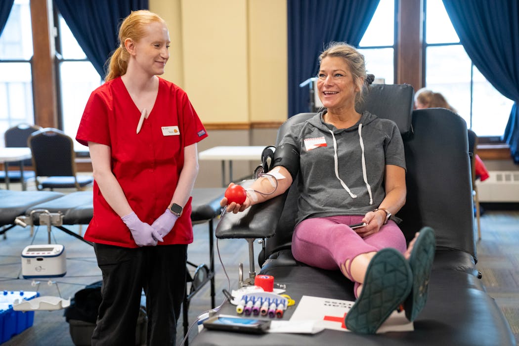 Tessa LePlavy, a phlebotomist, chats with Kari Splinter as she donates blood during a Red Cross blood drive at Union Depot in St. Paul on Thursday, June 20. 