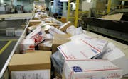 CORRECTS YEAR TO 2017 INSTEAD OF 2018 - FILE - In this Dec. 14, 2017 file photo, packages travel on a conveyor belt for sorting at the main post offic