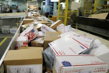 CORRECTS YEAR TO 2017 INSTEAD OF 2018 - FILE - In this Dec. 14, 2017 file photo, packages travel on a conveyor belt for sorting at the main post offic