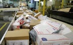 CORRECTS YEAR TO 2017 INSTEAD OF 2018 - FILE - In this Dec. 14, 2017 file photo, packages travel on a conveyor belt for sorting at the main post offic