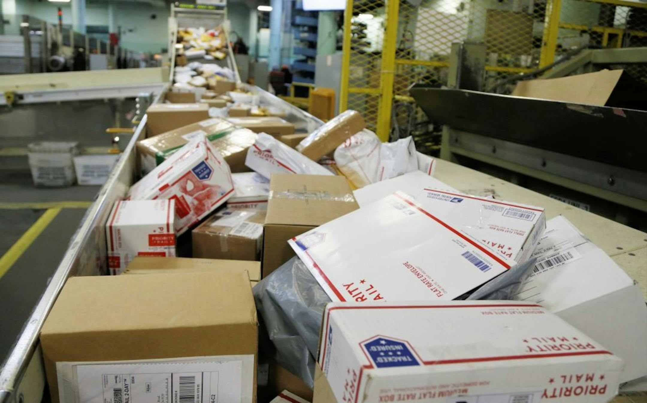 CORRECTS YEAR TO 2017 INSTEAD OF 2018 - FILE - In this Dec. 14, 2017 file photo, packages travel on a conveyor belt for sorting at the main post office in Omaha, Neb. The shipment of several pipe bombs to CNN and several prominent Democrats raises fresh questions about mail safety and what measures the U.S. Postal Service and private delivery services take to prevent explosives and other illegal substances from entering into the mail.