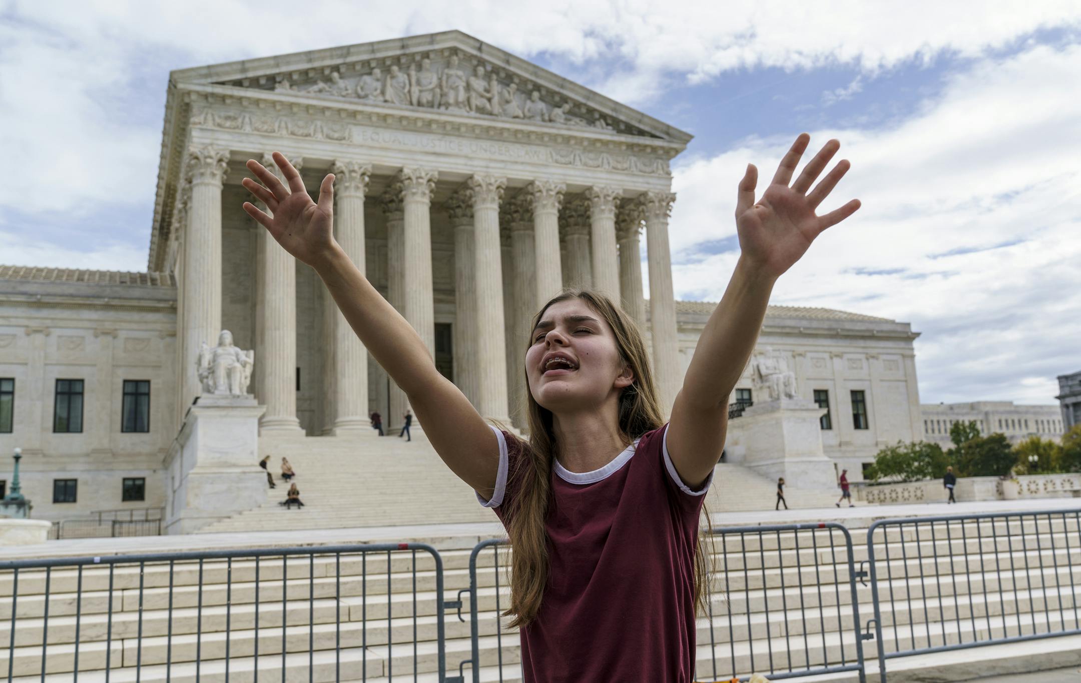 Elsie Paliy, of Jacksonville, Fla., joins other evangelical Christians praying outside the Supreme Court as Republicans in the Senate work in a rare weekend session to advance the confirmation of Judge Amy Coney Barrett for the high court, in Washington, Saturday, Oct. 24, 2020. (AP Photo/J. Scott Applewhite)