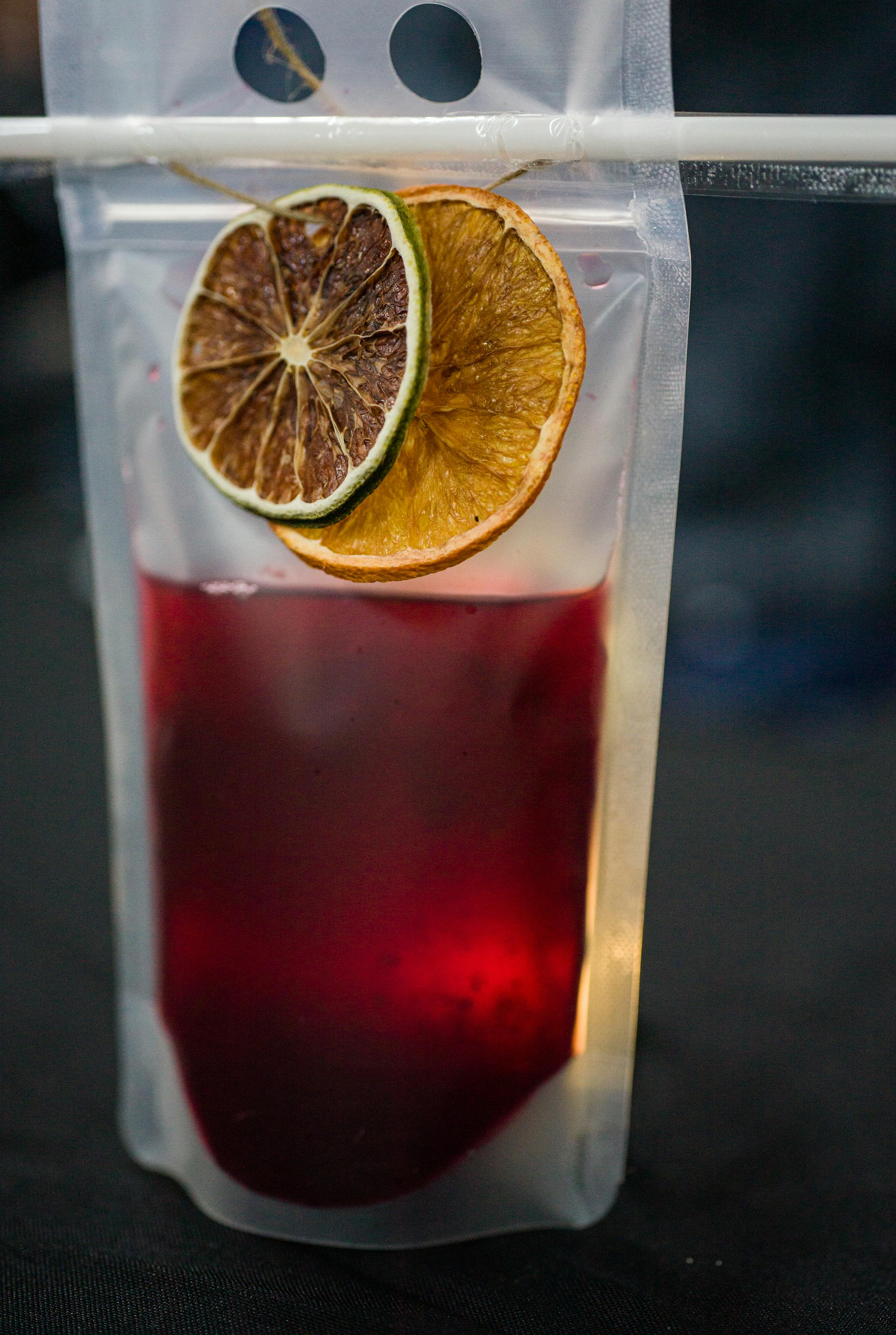 A hibiscus tea with dehydrated lemon slices  is paired with the lamb birria.