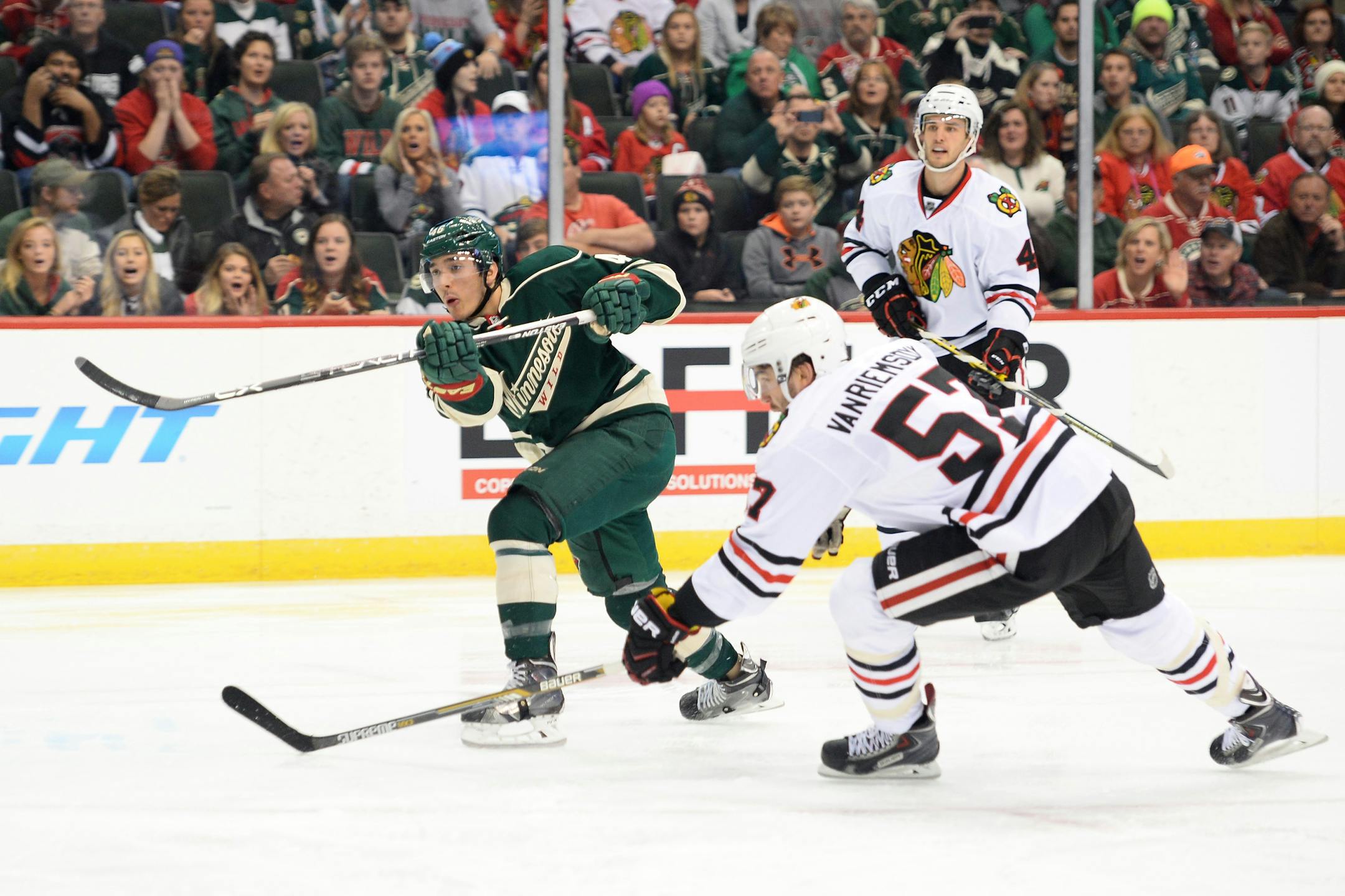 The Minnesota Wild's Jared Spurgeon, left, scores against the Chicago Blackhawks in the second period