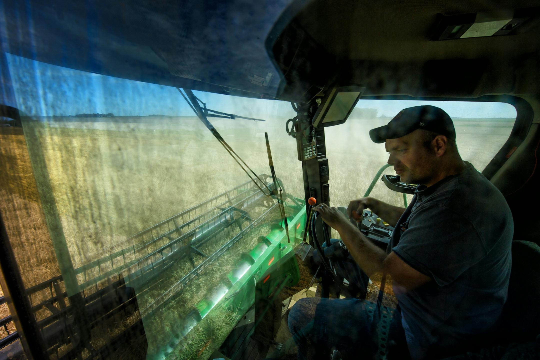 Jack Weber drove his wheat combine on his field. The wheat doesn't bring much cash but it does improve the health of his soil.