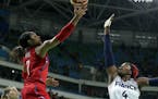 United States' Maya Moore, left, shoots over France's Isabelle Yacoubou, right, during a semifinal round basketball game at the 2016 Summer Olympics i