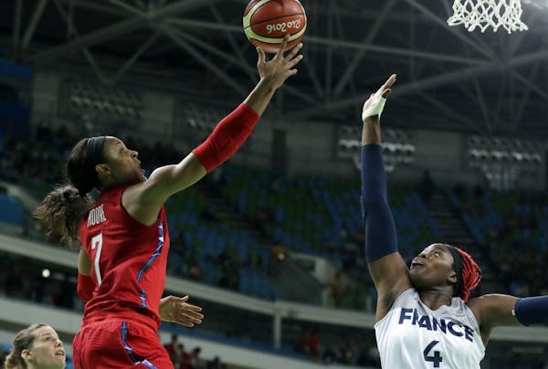 United States' Maya Moore, left, shoots over France's Isabelle Yacoubou, right, during a semifinal round basketball game at the 2016 Summer Olympics i