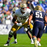Notre Dame offensive lineman Joe Alt (76) in action against Navy linebacker Nicholas Straw (51) during the first half of an NCAA college football game
