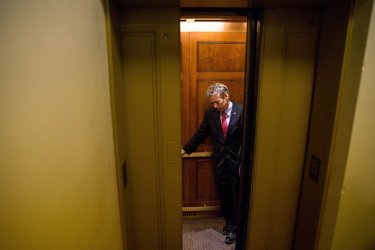 Republican presidential candidate, Sen. Rand Paul, R-Ky. departs in an elevator after speaking at a news conference on Capitol Hill in Washington, Tuesday, June 2, 2015, calling for the 28 classified pages of the 9-11 report to be declassified. Paul has been voicing his dissent in the Senate against a House bill backed by the president that would end the National Security Agency's collection of American calling records while preserving other surveillance authorities. (AP Photo/Andrew Harnik)