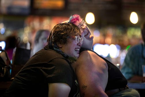 Annie Chen, left and Marty Viscos enjoyed the musics during Tuesday night karaoke at Black Hart of St. Paul bar August 1,2023 in St. Paul.,Minn. ] JERRY HOLT • jerry.holt@startribune.com