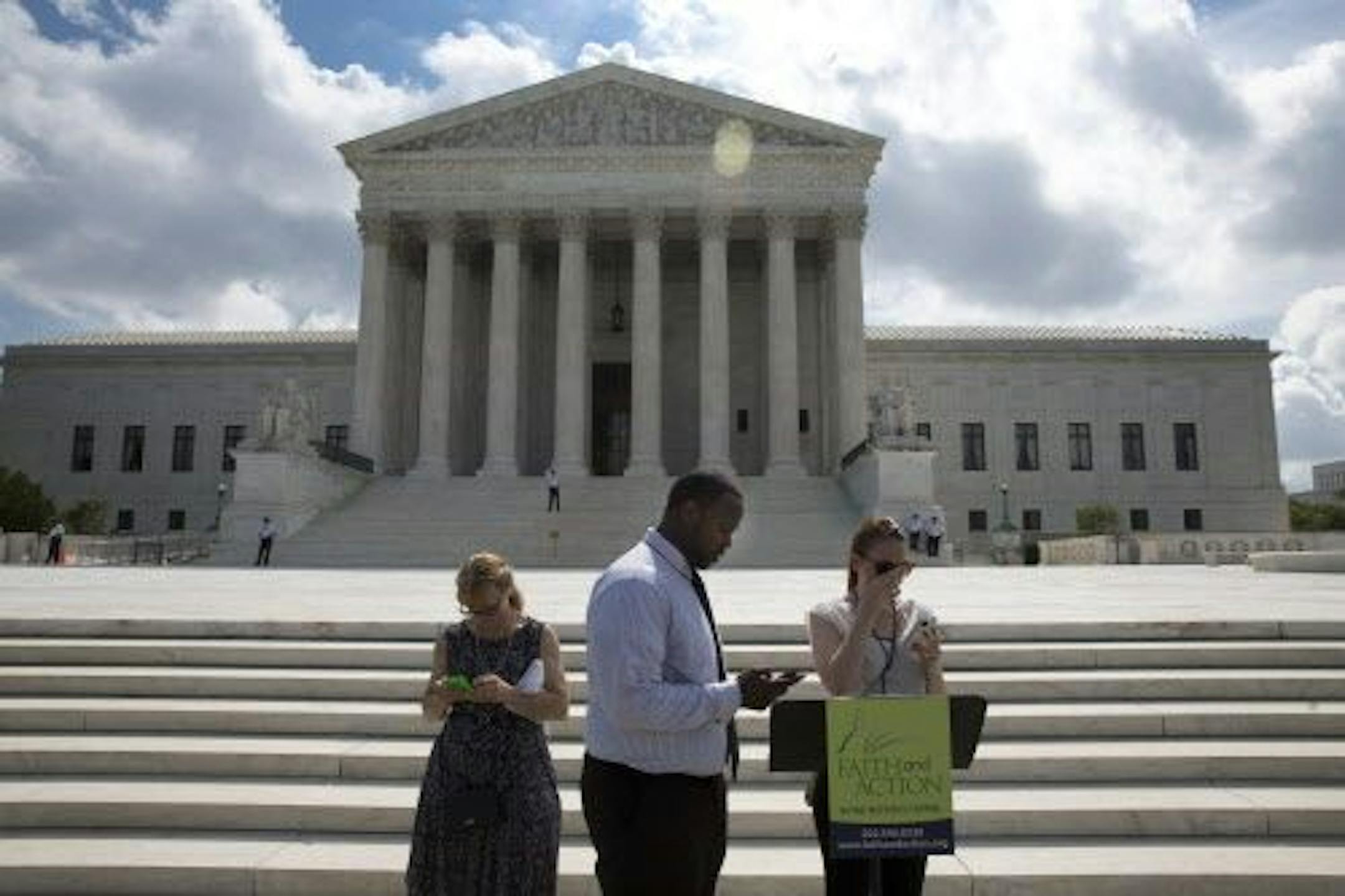 Activists stood in front of the Supreme Court building, on Capitol Hill in Washington, June 25, 2014.