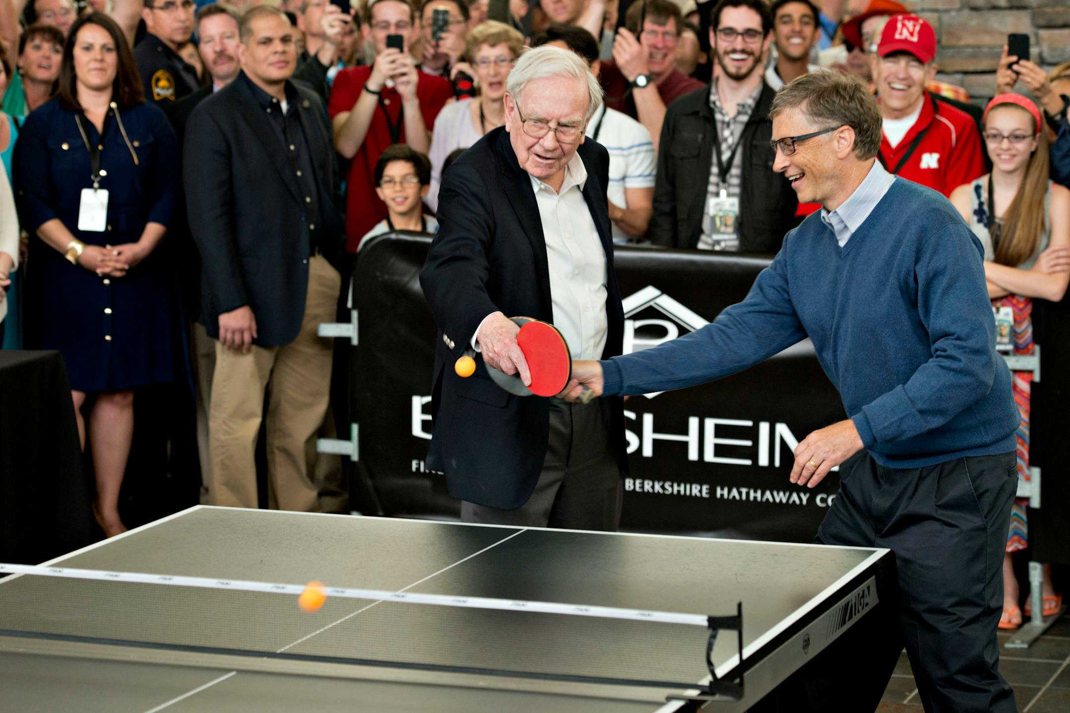 Warren Buffett, chairman of Berkshire Hathaway Inc., left, plays ping pong with Bill Gates, chairman and founder of Microsoft Corp. and Berkshire Hathaway Inc. director, during a shareholder event on the sidelines of the Berkshire Hathaway shareholders meeting in Omaha, Nebraska, U.S., on Sunday, May 4, 2014. Warren Buffett whose Berkshire Hathaway Inc. joined 3G Capital last year in a $23.3 billion takeover of ketchup maker HJ Heinz Co., said yesterday he'd welcome more deals with the buyout fi