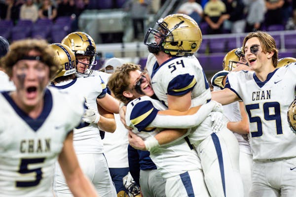 Chanhassen players celebrate after winning the Class 5A football state semifinals against Andover Saturday, Nov. 18, 2023 at U.S. Bank Stadium. Nicole