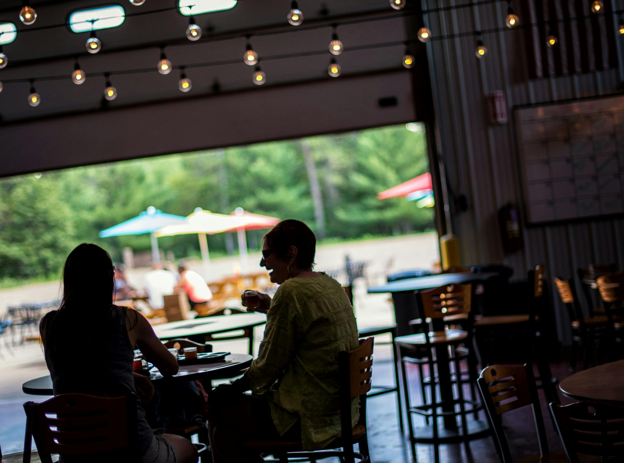 Shirley Zablocki, right and her daughter Juliana Lueneburg, left, ordered a flight of beers at Gull Dam Brewing tap room in Nisswa, MN which was still open for business despite the storm that rolled through the area. ] GLEN STUBBE * gstubbe@startribune.com Friday, July 17, 2015