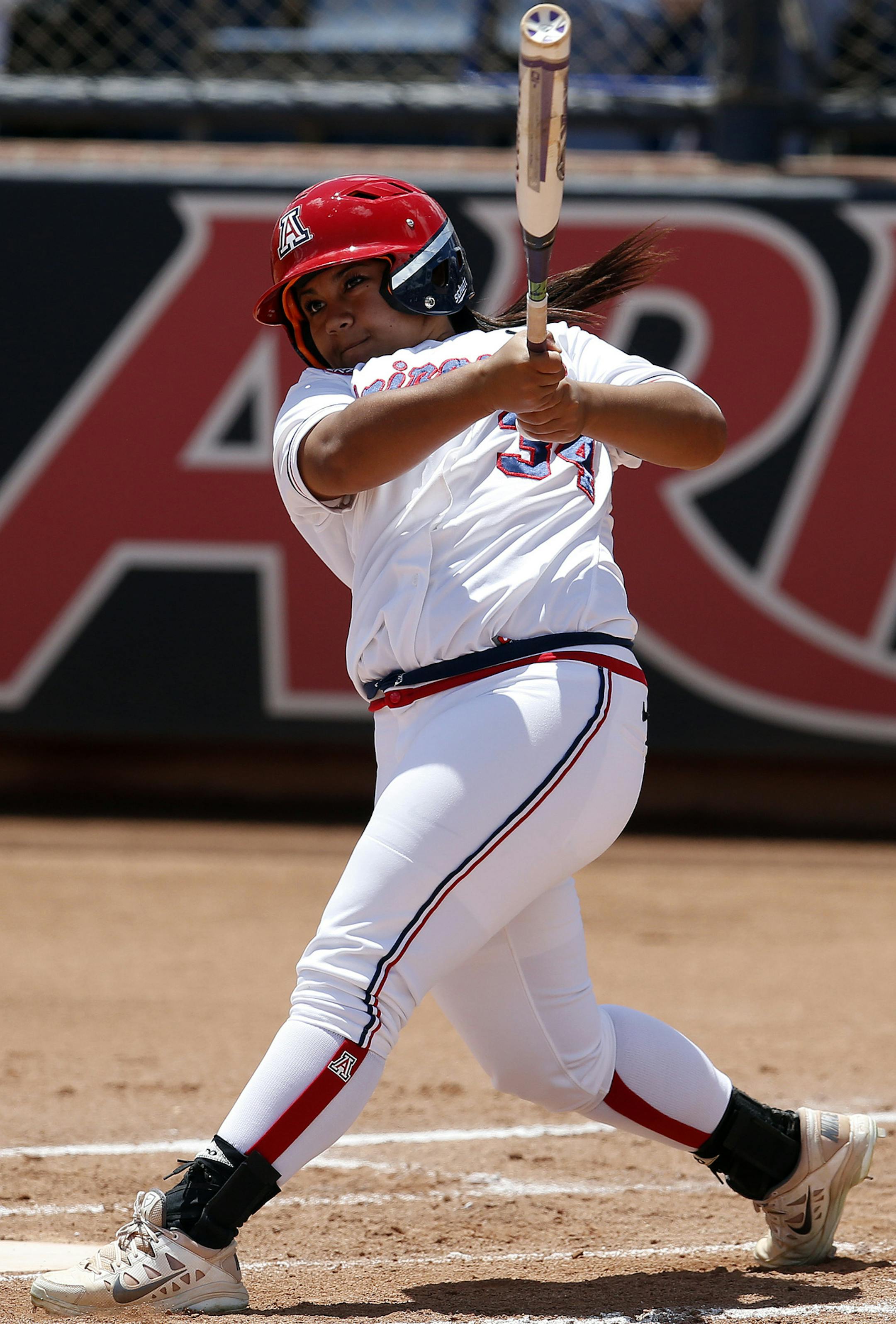Arizona's Katiyana Mauga hits a solo home run in the second inning during an NCAA college softball tournament regional game against Minnesota, Saturday, May 16, 2015, in Tucson, Ariz. (AP Photo/Rick Scuteri)