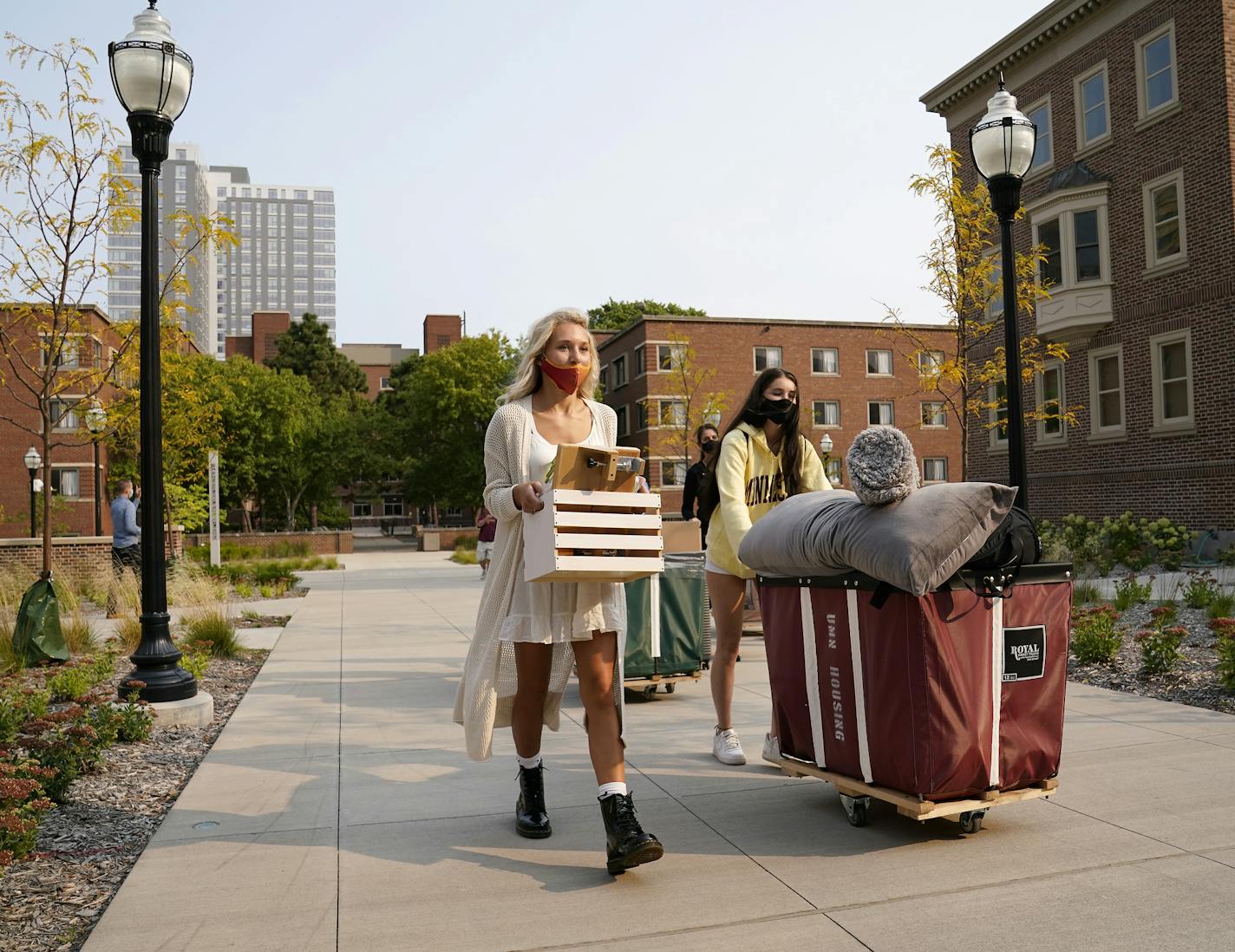 University of Minnesota freshman Chloe Wienholz, left, of Stillwater, and step sister Savanna Hatzenbuhler, of Woodbury, carried and pushed their belongings towards their new dorm rooms on campus Tuesday, in Minneapolis. ] DAVID JOLES • david.joles@startribune.com Students begin moving into dorms on the University of Minnesota's flagship campus Tuesday.**Chloe Wienholz, Savanna Hatzenbuhler,cq