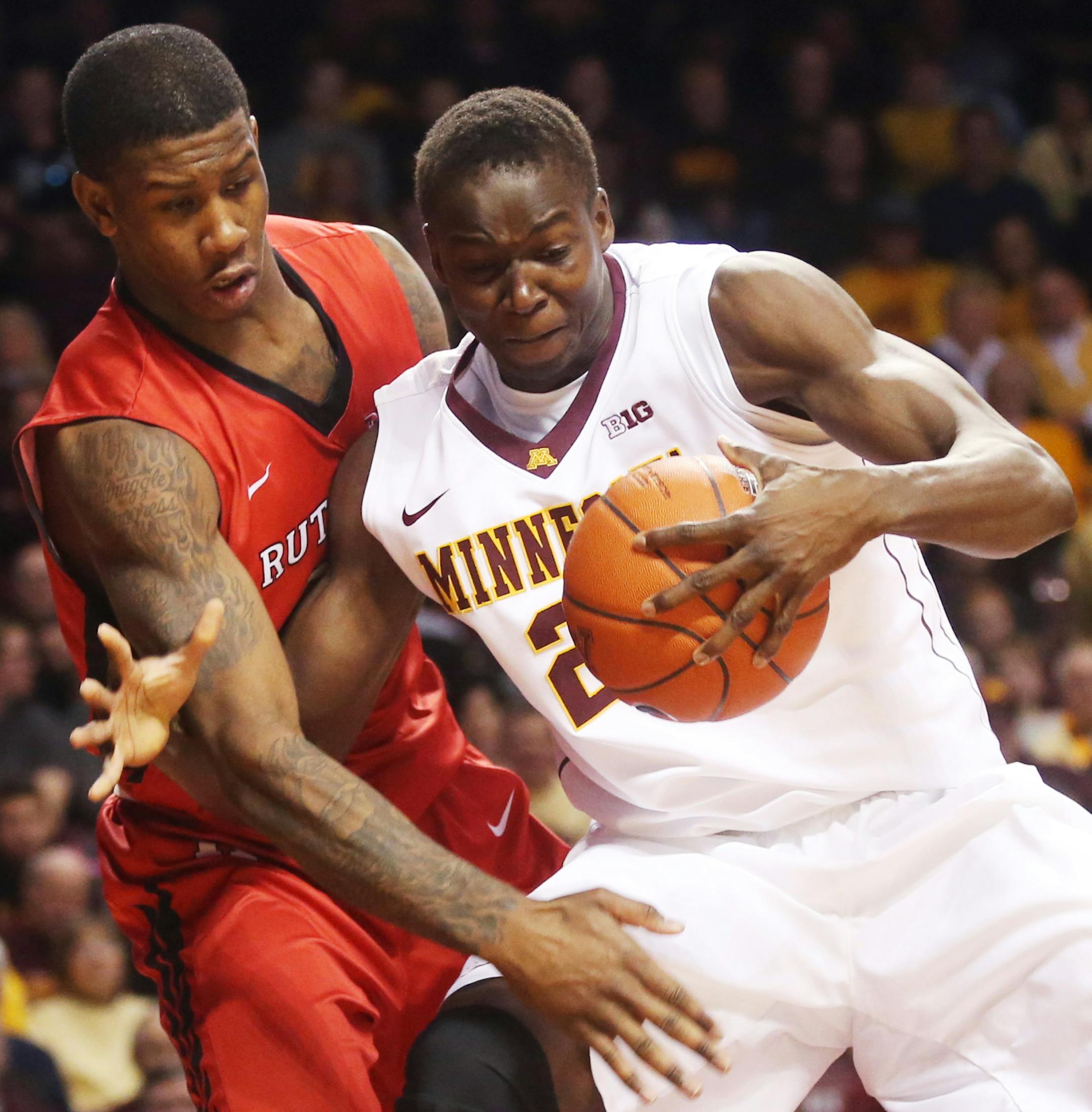 Minnesotaís Bakary Konate, right, of Mali, gets tangled up by Rutgersís Greg Lewis in the second half of an NCAA college basketball game, Saturday, Jan. 17, 2015, in Minneapolis. Lewis was called for a foul on the play. Minnesota won 89-80. (AP Photo/Jim Mone) ORG XMIT: MIN2015022517582870