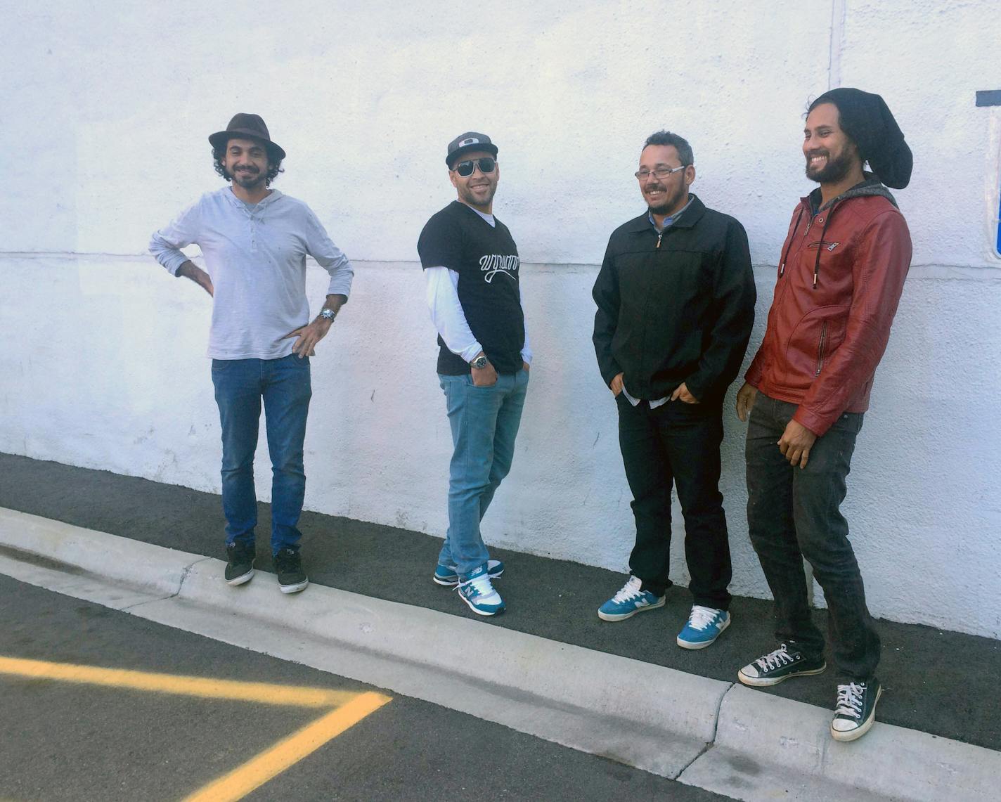 Brazilian street artist Eduardo Kobra (left) and his three team members &#xf3; Silvio Cesar Gon&#xc1;alves de Almeida, Marcos Rafael da Silva and Agnaldo Brito Pereira (in order) at the site of upcoming mural on Fifth Street and Hennepin Avenue.