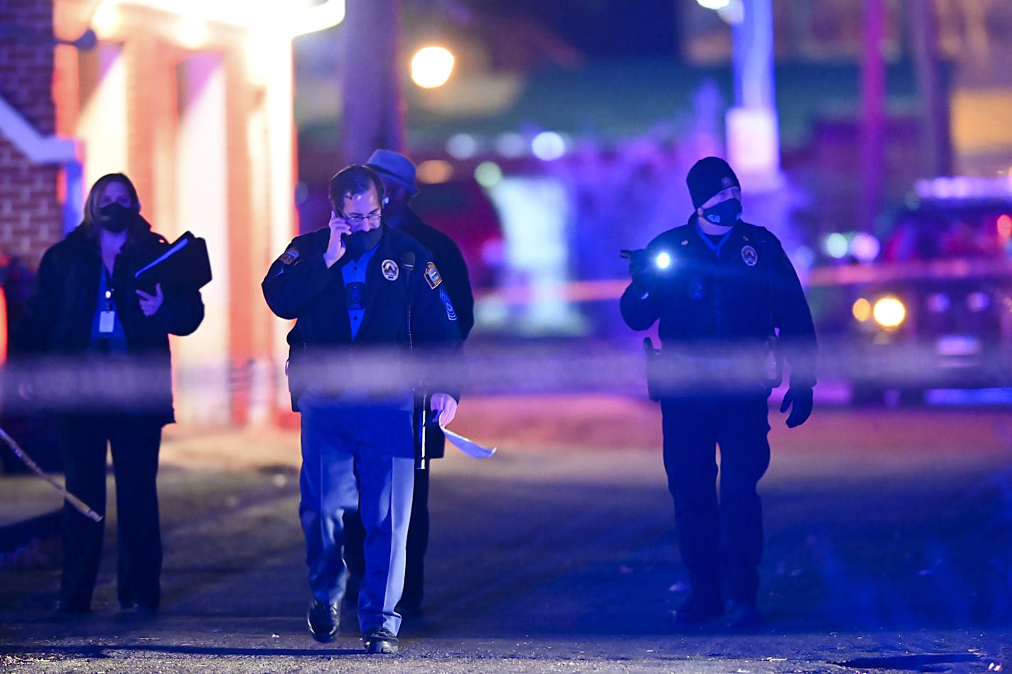 St. Paul police officers and Bureau of Criminal Apprehension investigators walked near the scene where Joseph Javonte Washington was shot Saturday.