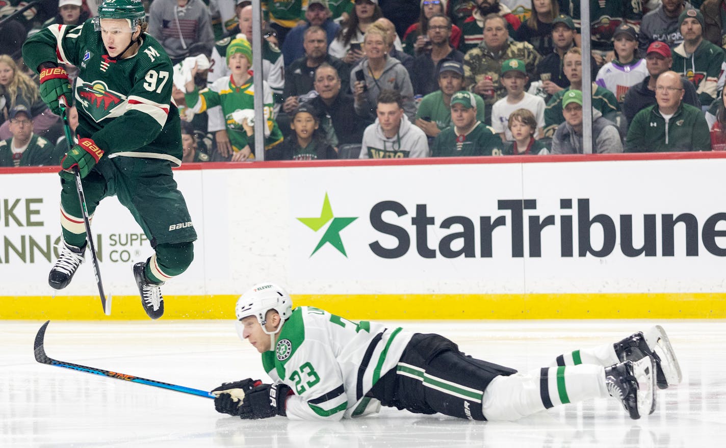 Kirill Kaprizov (97) of the Minnesota Wild leaps over Esa LIndell (23) of the Dallas Stars in the first period during Round 1, Game 4 of the NHL playoffs Sunday, April 23, 2023, at Xcel Energy Center in St. Paul, Minn. ] CARLOS GONZALEZ • carlos.gonzalez@startribune.com.