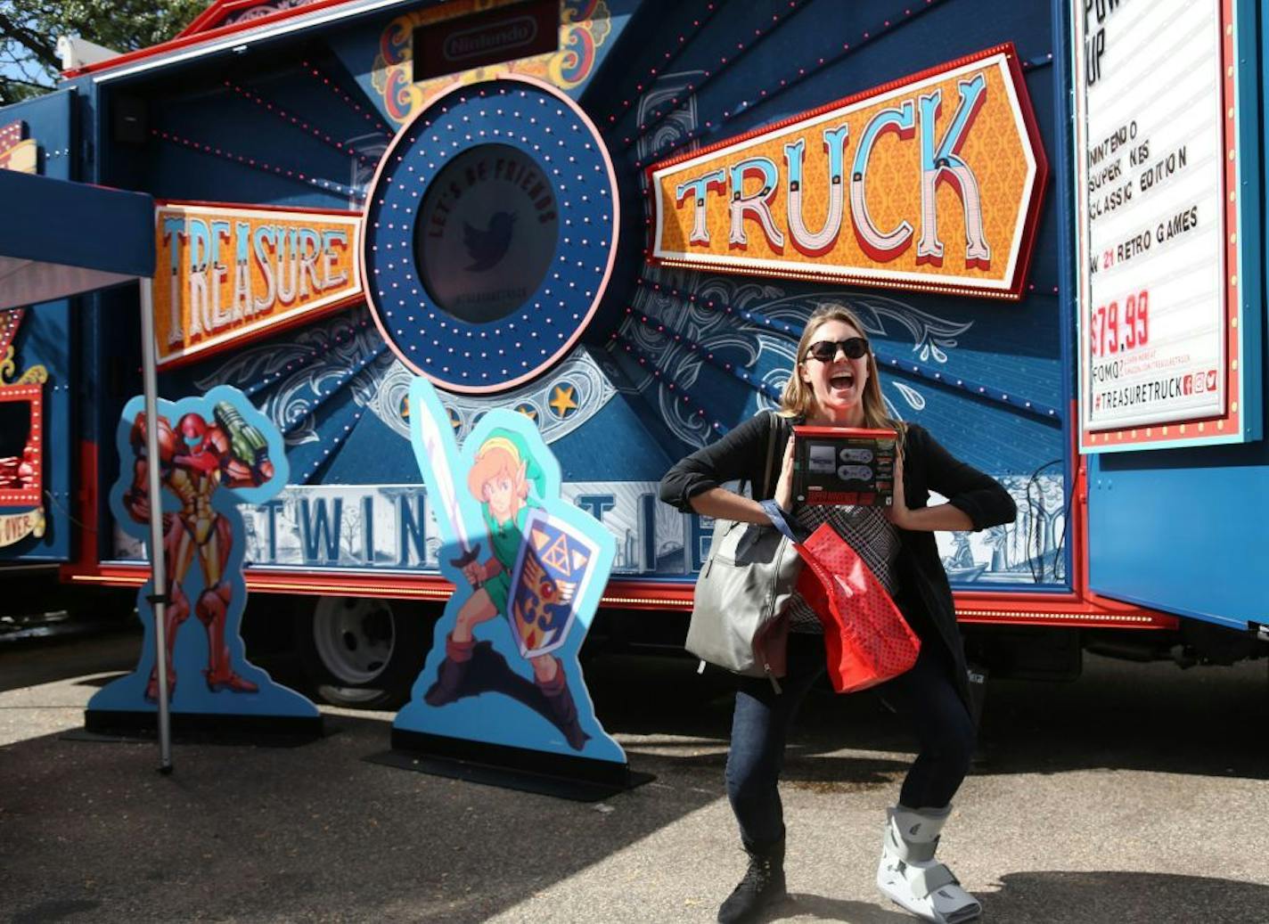 Courtney Lang, of Minneapolis, poses with her Nintendo SNES Classic Edition she picked up at Amazon's Treasure Truck in downtown Minneapolis.