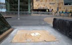 Plywood marks the spot where a statue of former Minnesota Twins owner Calvin Griffith stood outside Target Field.