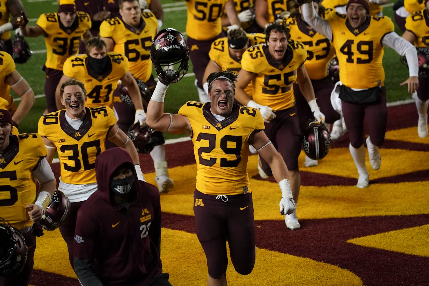 Linebacker Josh Aune (29) ran off the field cheering with teammates after his late interception helped the Gophers edge Purdue 34-31. But a COVID-19 outbreak with the team has canceled its next game with rival Wisconsin on Saturday.