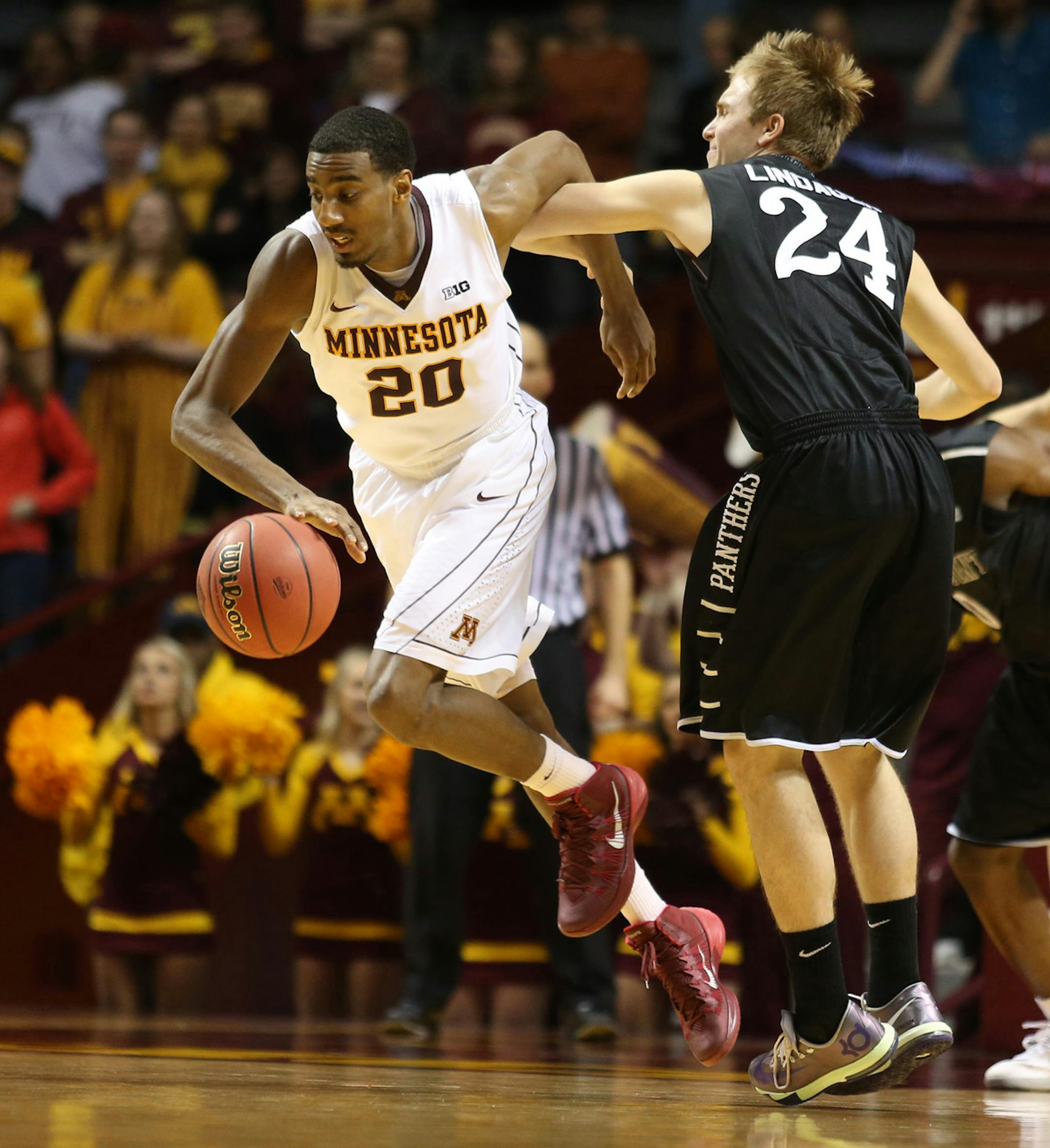 Gopher Austin Hollins stole the ball away from High Point's Anthony Lindauer in the second half. ] (KYNDELL HARKNESS/STAR TRIBUNE) kyndell.harkness@startribune.com First round of the National Invitational Tournament at Williams Arena in Minneapolis Min, Tuesday March 18, 2014.