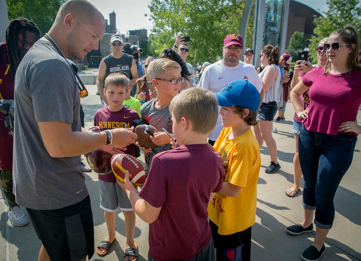 P. J. Fleck signed autographs before a practice at TCF Bank Stadium earlier this month. The Gophers still are trying to attract a major piece of the Twin Cities sports market.