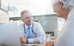 Shot of a doctor talking to a senior patient in his office. iStock
