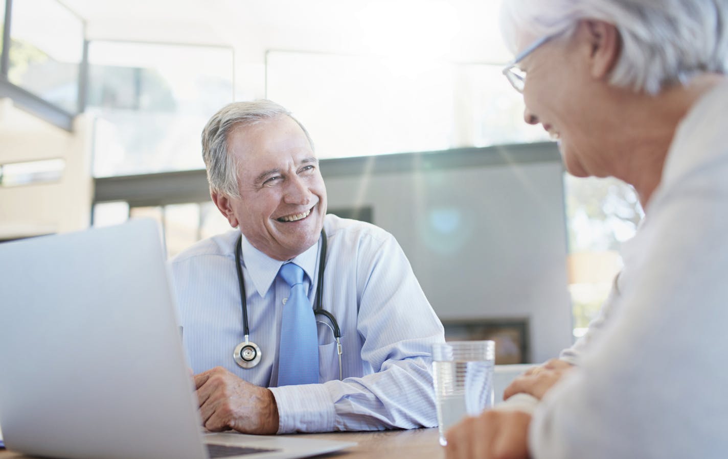 Shot of a doctor talking to a senior patient in his office. iStock