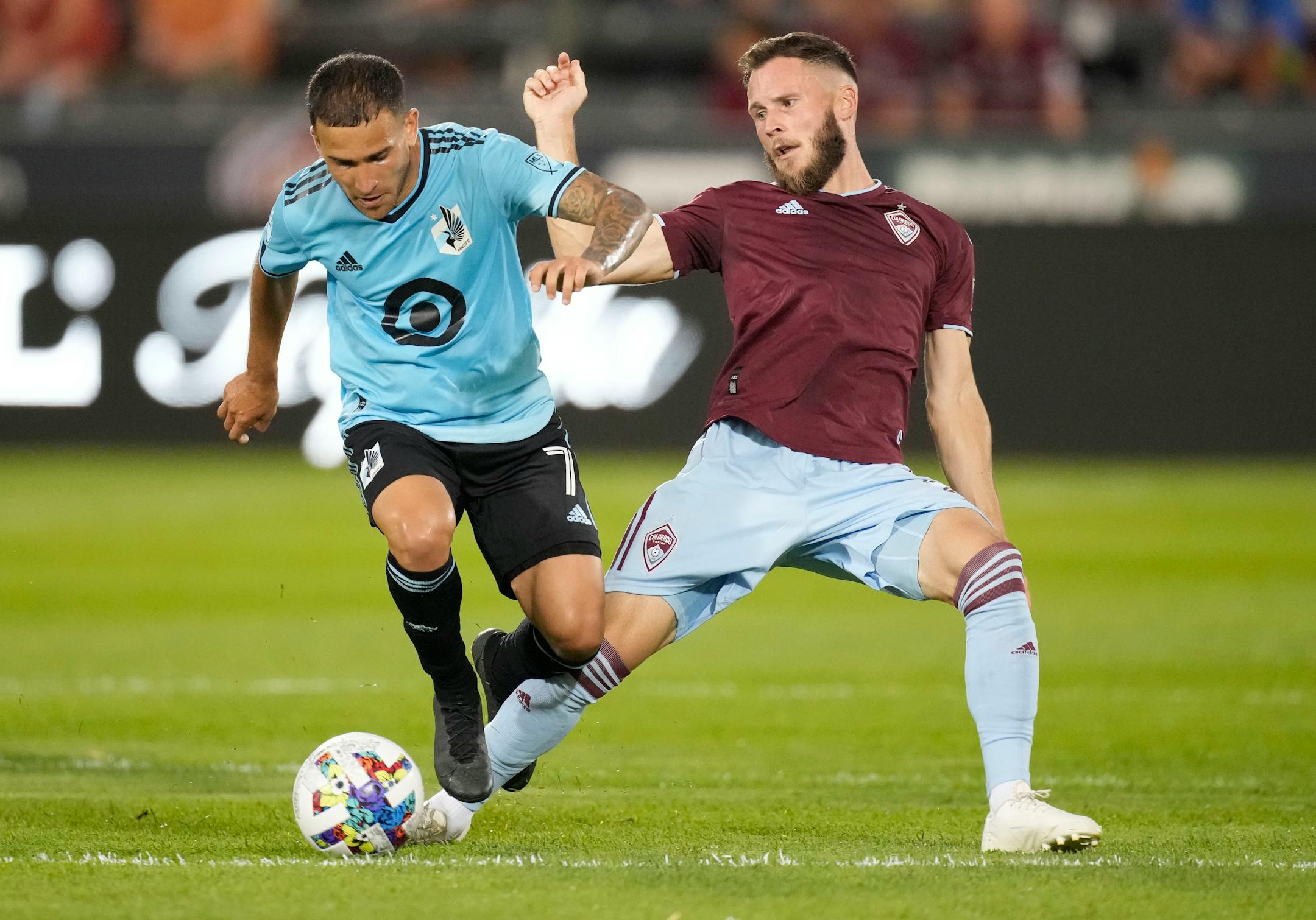 Loons midfielder Franco Fragapane, left, tries to control the ball next to Colorado Rapids defender Keegan Rosenberry during the first half Saturday