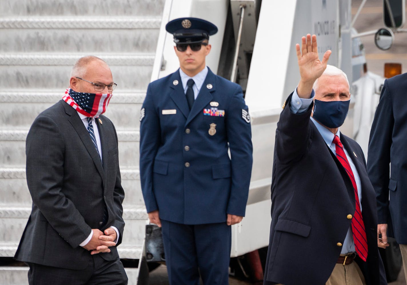 Vice President Mike Pence, followed by Rep Pete Stauber, waves as he heads to his motorcade after arriving at the Duluth International Airport for a campaign stop in Duluth, Minn., Friday, Aug. 28, 2020. (AP Photo/Jack Rendulich)