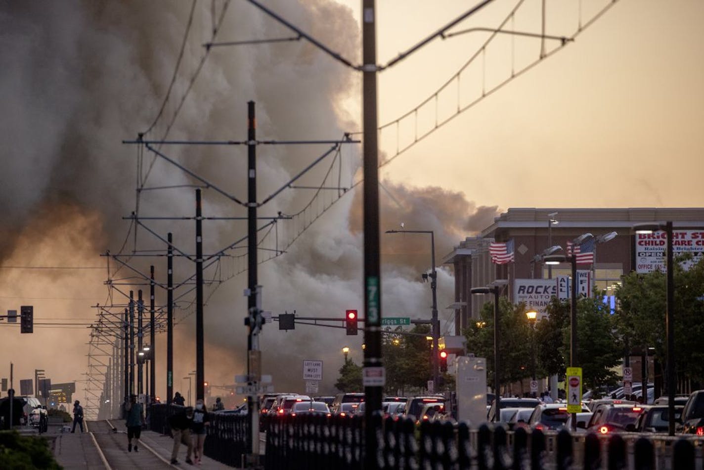 Smoke rises from fires as seen from University Avenue on Thursday, May 28, 2020, in St. Paul, Minn. Anger over the death of George Floyd, a handcuffed black man in police custody, spread beyond Minneapolis on Thursday, with looting and fires set along a major St. Paul street and protesters returning to a neighborhood already ravaged by violent protest.