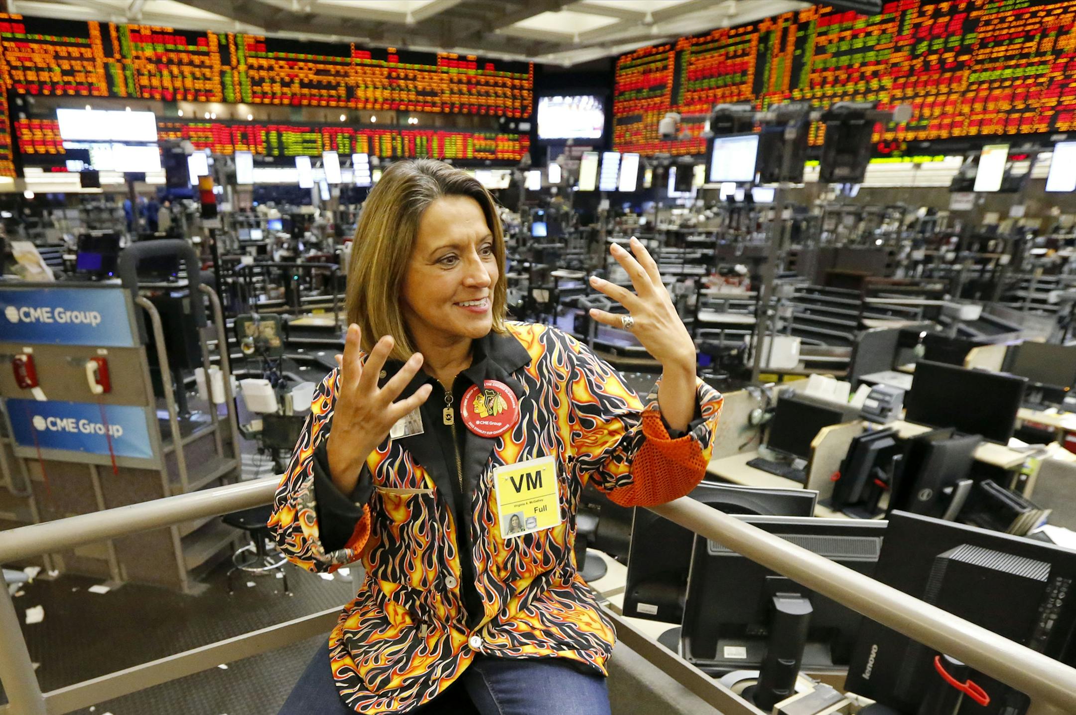 In this Wednesday, July 1, 2015, photo, commodities broker Virginia McGathey talks about the demise of the agricultural futures pits after trading ended for the day at the CME Group in Chicago. Most pits in Chicago and New York where traders bet on future prices of palladium and gold, cattle and corn and dozens of other commodities are expected to close for good on Monday, July 6, 2015. (AP Photo/Charles Rex Arbogast) ORG XMIT: NYBZ707