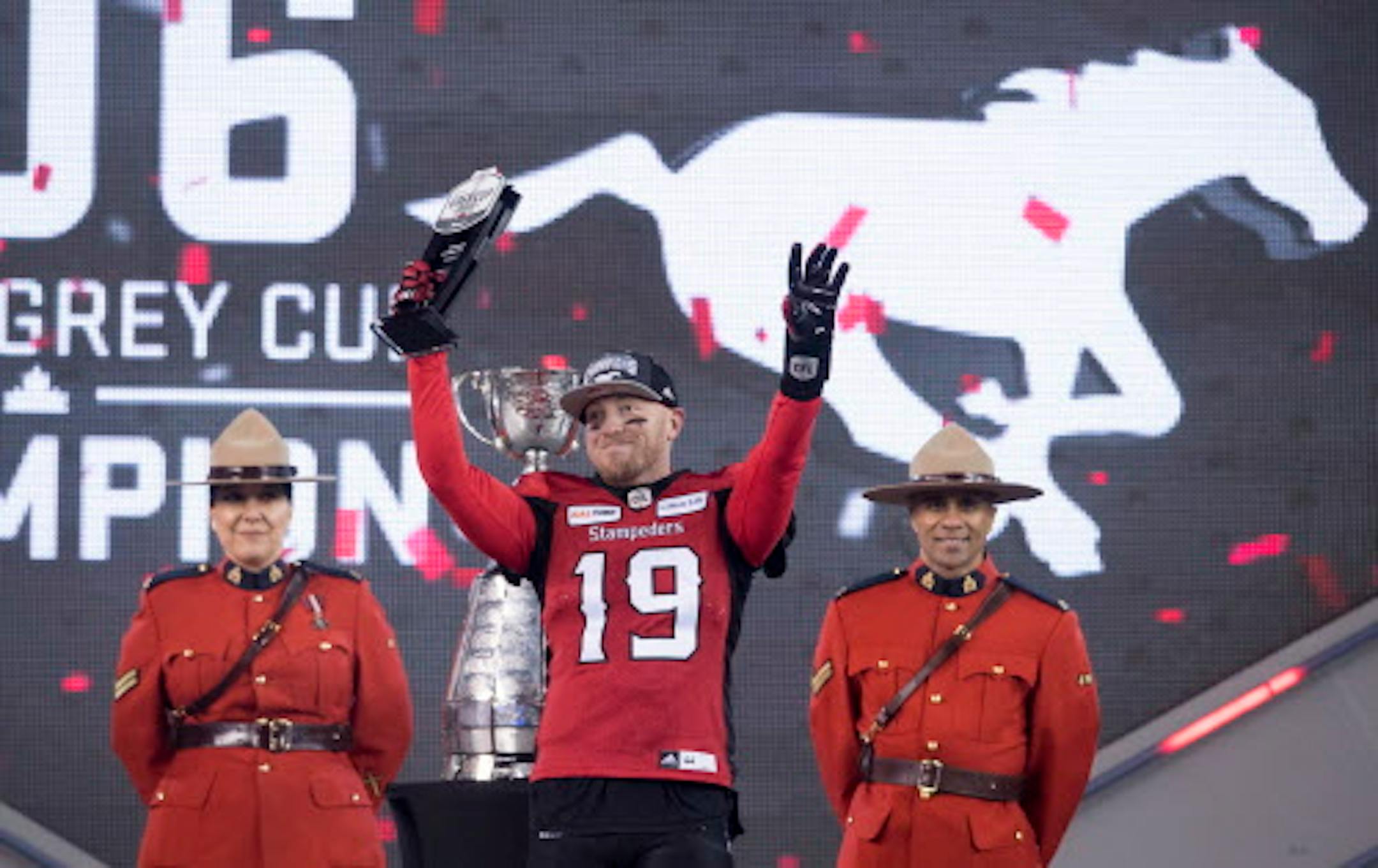 Calgary Stampeders quarterback Bo Levi Mitchell (19) holds up the MVP trophy after the Stampeders defeated the Ottawa Redblacks in the Canadian Football League Grey Cup in Edmonton, Alberta, Sunday, Nov. 25, 2018. (Nathan Denette/The Canadian Press via AP)