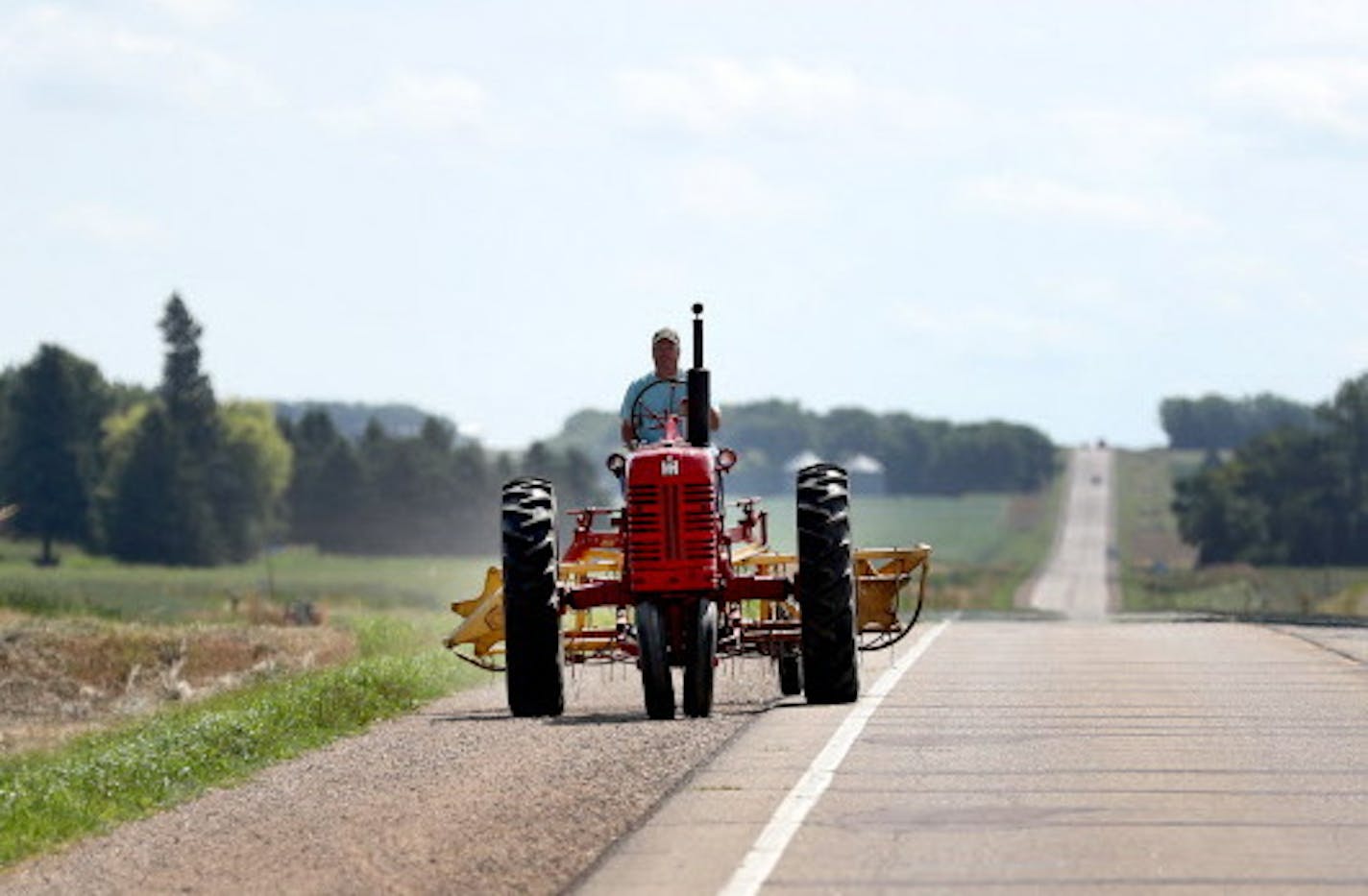 Farmer Jim York returns to his farm on Highway 30 after raking ditch hay with his International Harvester Farmall 400 tractor, similar to the one that was donated to a small village in Burkina Faso and was seen Wednesday, June 29, 2016, in Lake Wilson, MN.](DAVID JOLES/STARTRIBUNE)djoles@startribune A bright red tractor donated by farmers in rural Minnesota rolled into a tiny village in Burkina Faso last week, planting seeds of hope to impoverished farmers. An entire village in Guatemala is bein