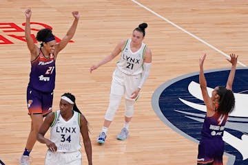 Phoenix Mercury forward Brianna Turner (21), left, and Phoenix Mercury guard Skylar Diggins-Smith (4), right, celebrated their 77-75 win as Minnesota 