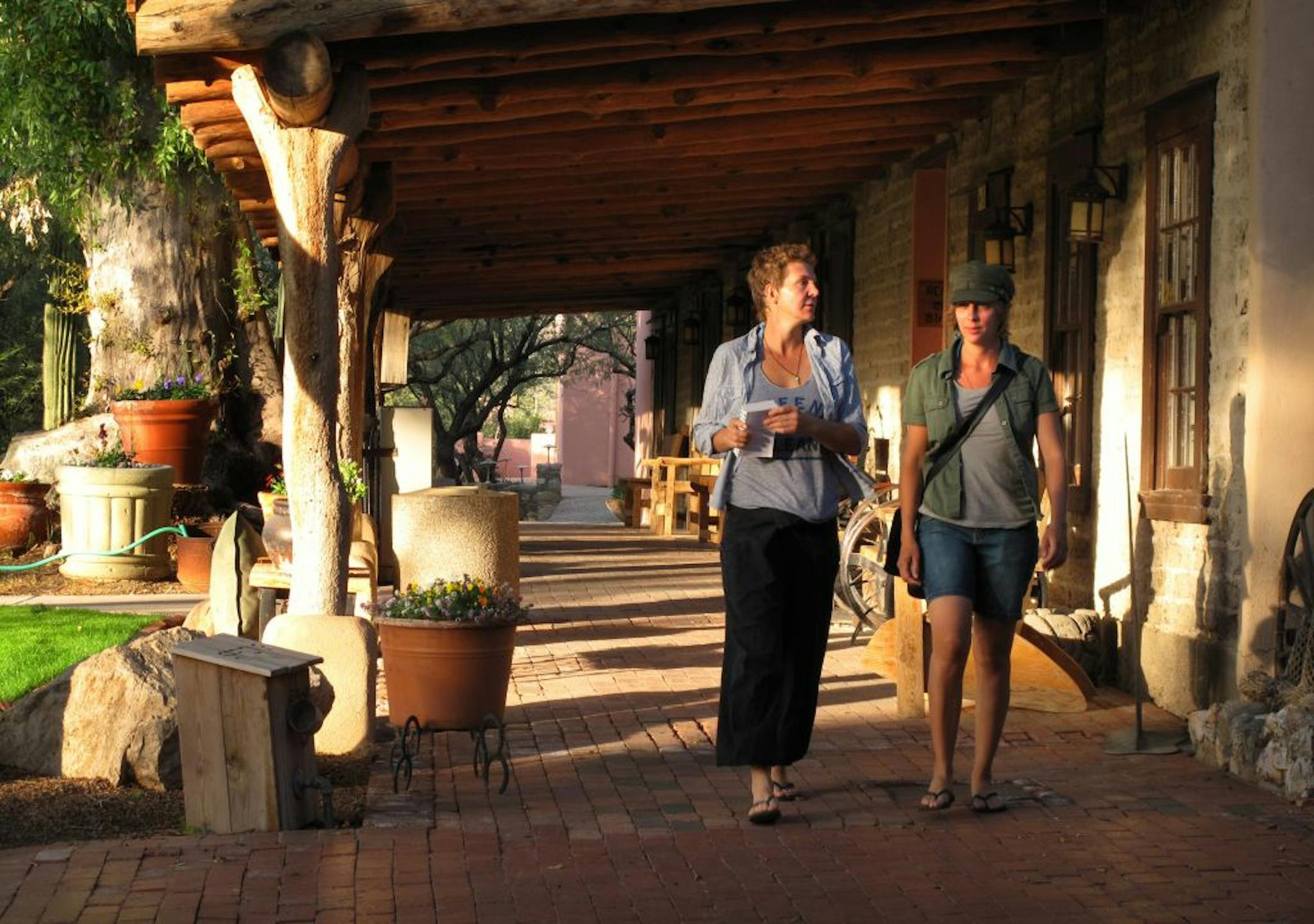 Two women from Paris stroll down the promenade that connects the dining hall, activities center and the main lodge rooms.
