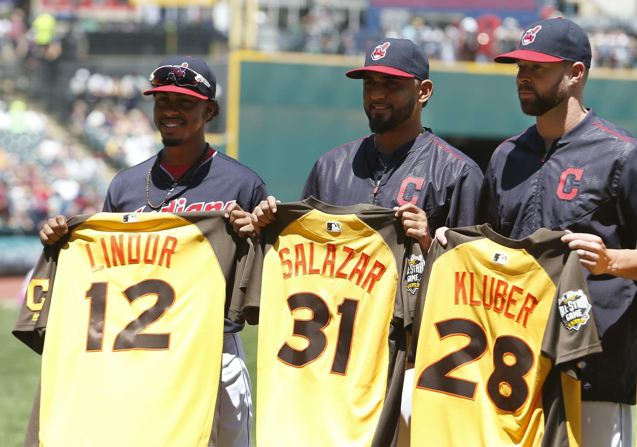 Cleveland Indians' Francisco Lindor (12), Danny Salazar (31) and Corey Kluber (28) receive their all star jerseys before a baseball game against the New York Yankees Sunday, July 10, 2016, in Cleveland. (AP Photo/Ron Schwane)