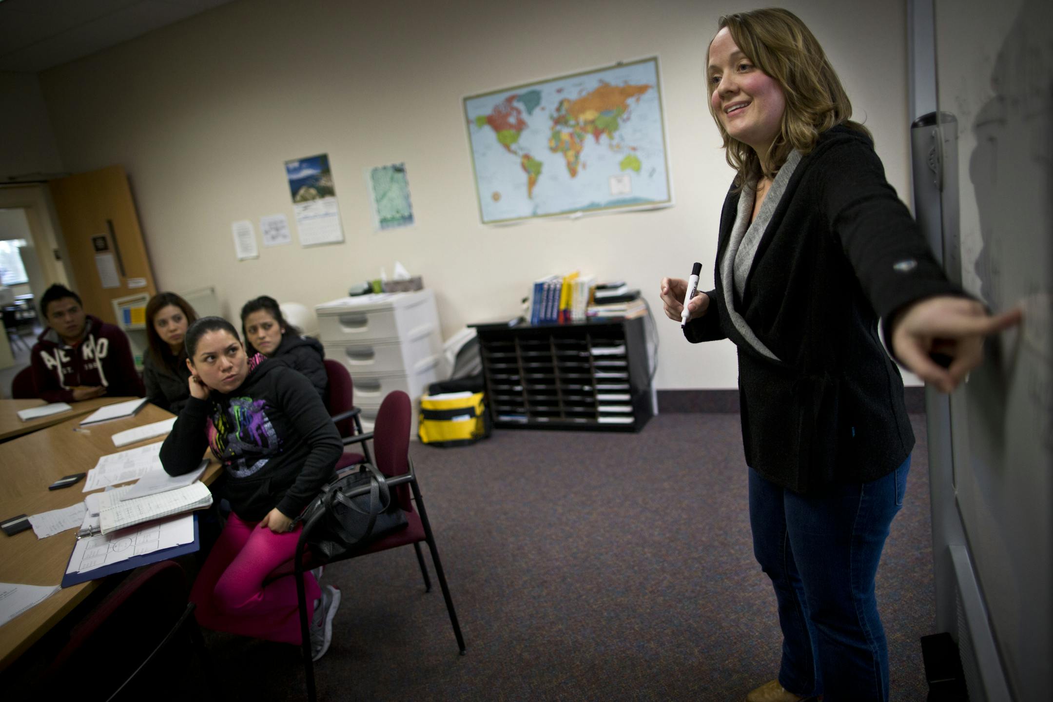 Teacher Clarice Grabau, right, did a math problem on a white board for students in a GED class at the Northfield Community Resource Center on Tuesday, March 12, 2013, in Northfield, Minn.