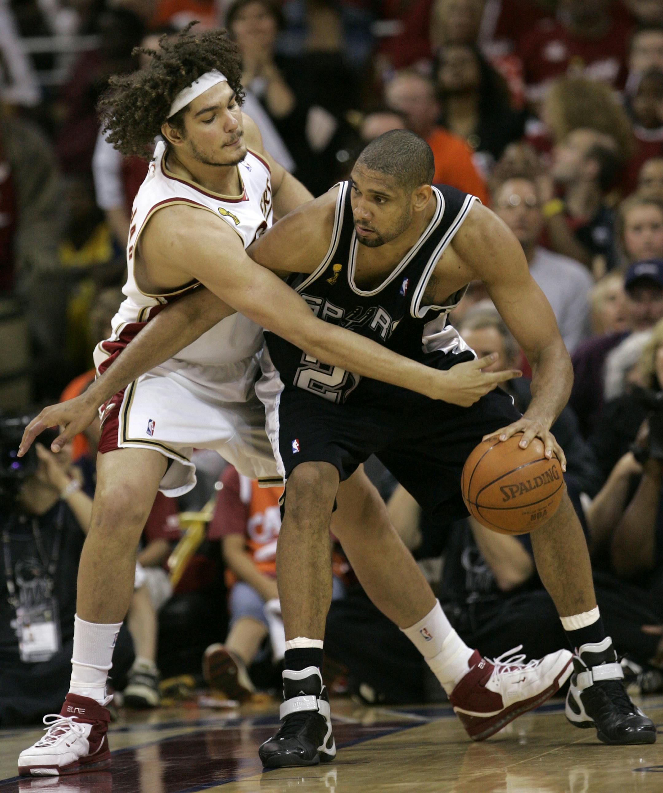 San Antonio Spurs' Tim Duncan, right, drives around Cleveland Cavaliers' Anderson Varejao, from Brazil, during the fourth quarter in Game 4 of the NBA basketball finals Thursday, June 14, 2007, in Cleveland. (AP Photo/Eric Gay) ORG XMIT: CDA225