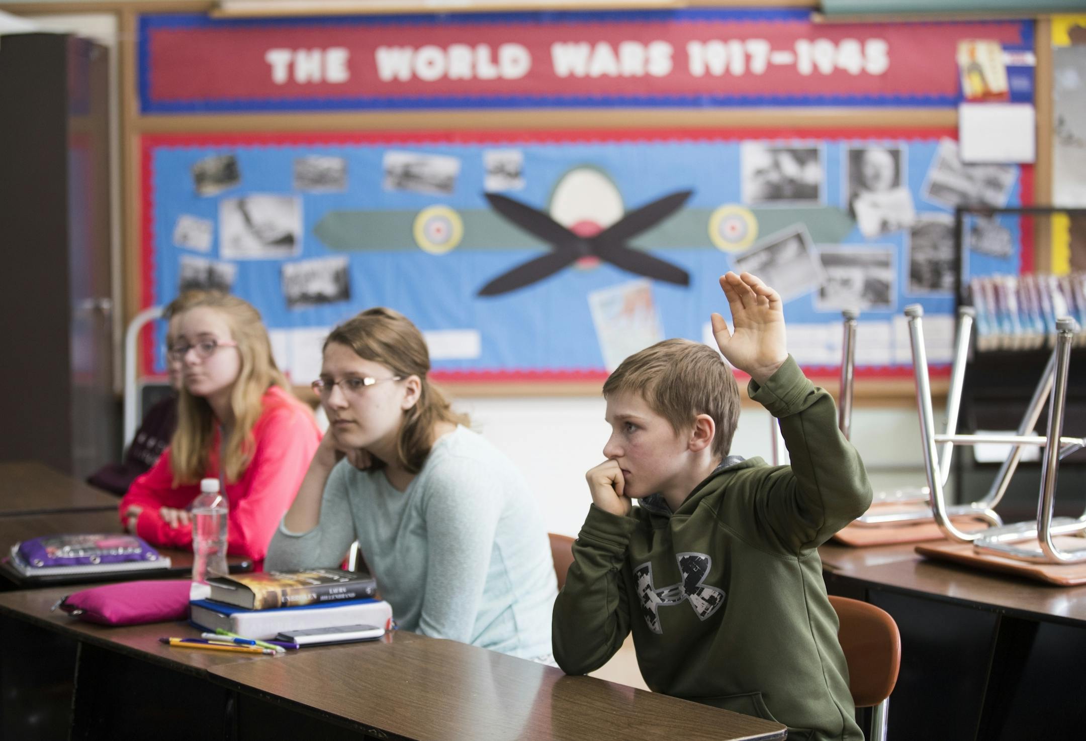Eighth grader Kyle Hagen raises his hand during class.